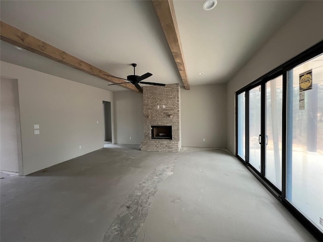 unfurnished living room with ceiling fan, beam ceiling, and a brick fireplace