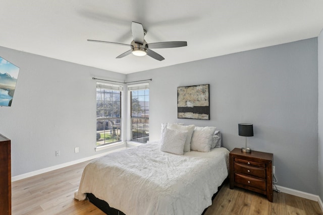 bedroom with ceiling fan and hardwood / wood-style floors