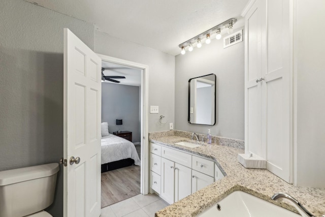 bathroom with vanity, ceiling fan, tile patterned floors, and toilet