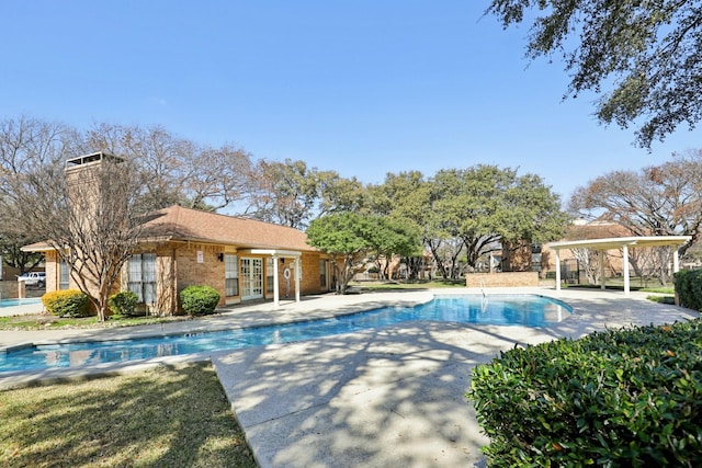 view of swimming pool with a patio