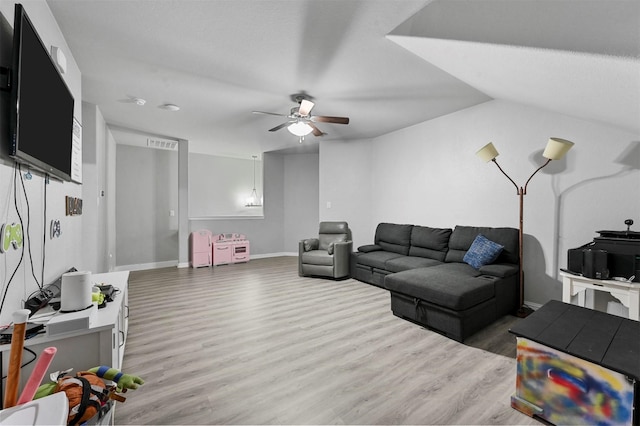 living room featuring hardwood / wood-style flooring and ceiling fan