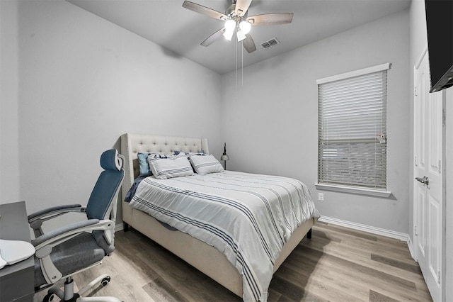 bedroom with hardwood / wood-style flooring and ceiling fan