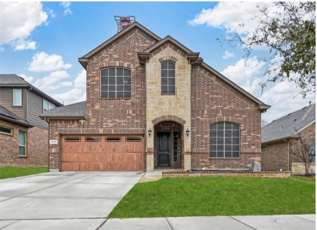 view of front of house featuring a garage and a front lawn