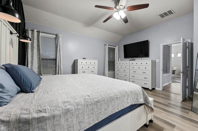 bedroom with wood-type flooring, ceiling fan, and vaulted ceiling