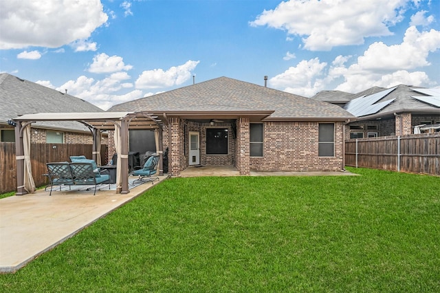 rear view of property with a pergola, a patio area, and a lawn