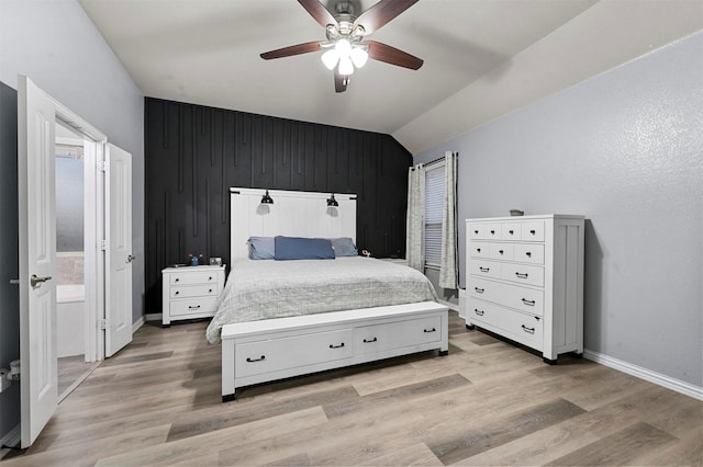 bedroom with vaulted ceiling, ceiling fan, and light wood-type flooring