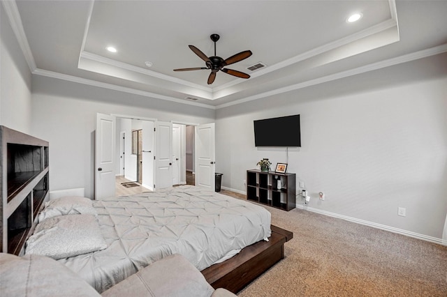 carpeted bedroom with crown molding, ceiling fan, and a tray ceiling