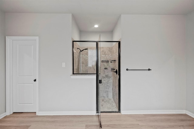 interior space with walk in shower and hardwood / wood-style floors