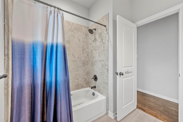 bathroom with shower / bathtub combination with curtain and hardwood / wood-style floors