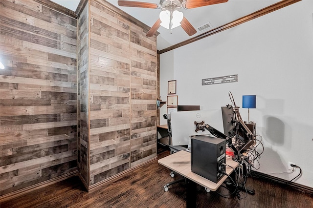 home office featuring ceiling fan, crown molding, dark hardwood / wood-style flooring, and wood walls