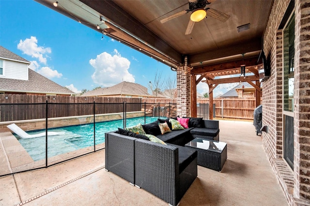 view of patio / terrace featuring pool water feature, grilling area, outdoor lounge area, ceiling fan, and a fenced in pool