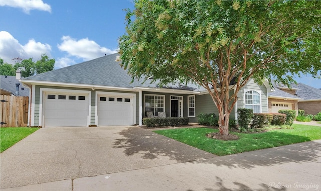 view of front facade featuring a garage and a front lawn