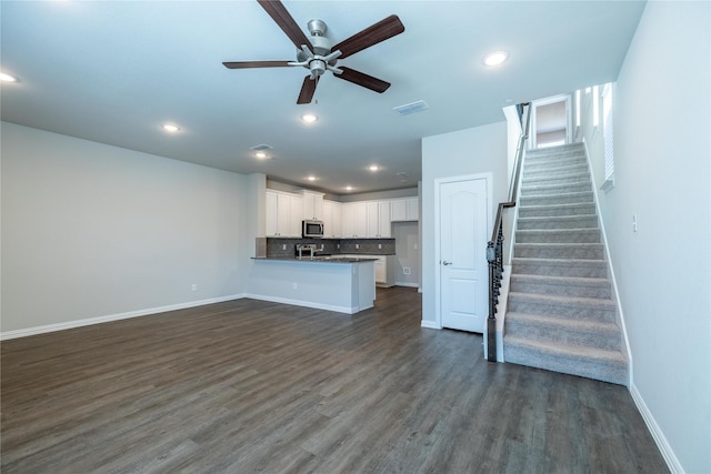 1267 Jones Trl, Lewisville, TX 75077 - unfurnished living room with a ceiling fan, stairway, dark wood-type flooring, baseboards, and recessed lighting