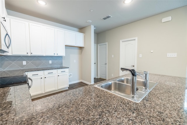 1267 Jones Trl, Lewisville, TX 75077 - kitchen with a sink, white cabinetry, backsplash, range with electric stovetop, and recessed lighting