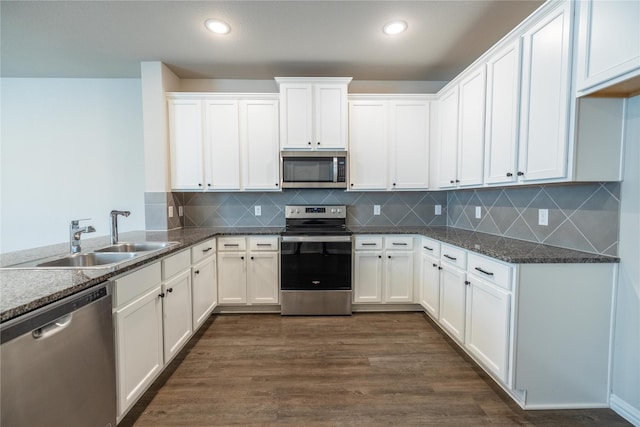 1267 Jones Trl, Lewisville, TX 75077 - kitchen featuring appliances with stainless steel finishes, a sink, white cabinetry, backsplash, and recessed lighting
