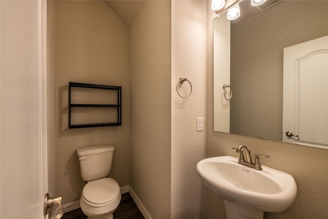 1267 Jones Trl, Lewisville, TX 75077 - half bath with a sink, toilet, baseboards, and wood finished floors