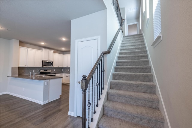 1267 Jones Trl, Lewisville, TX 75077 - staircase featuring wood finished floors, baseboards, and recessed lighting