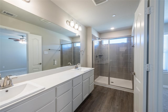 1267 Jones Trl, Lewisville, TX 75077 - full bathroom featuring a shower stall, wood finished floors, a ceiling fan, double vanity, and recessed lighting