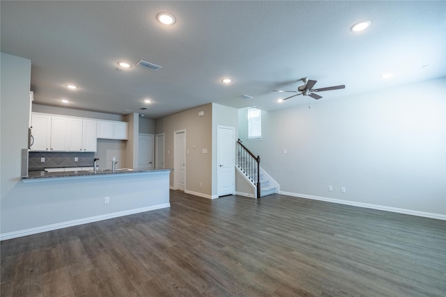 1267 Jones Trl, Lewisville, TX 75077 - unfurnished living room with stairway, recessed lighting, dark wood-style floors, a ceiling fan, and baseboards