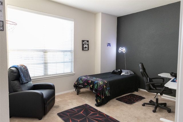 bedroom with multiple windows and light colored carpet