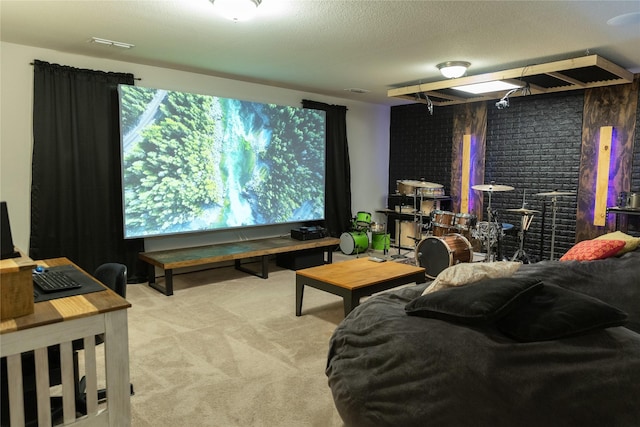 carpeted home theater room with brick wall and a textured ceiling