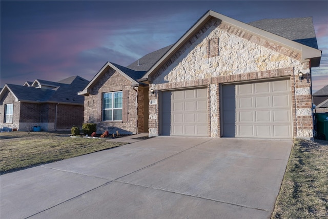 single story home featuring a garage and a lawn