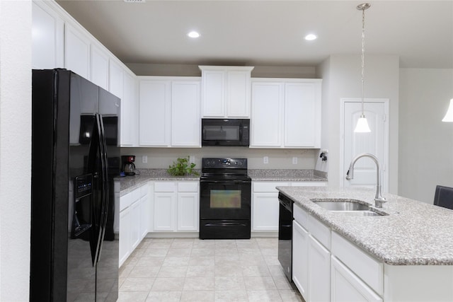 kitchen with sink, decorative light fixtures, black appliances, an island with sink, and white cabinets