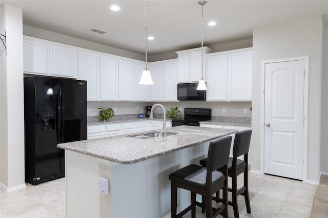 kitchen with white cabinetry, a kitchen island with sink, sink, and black appliances