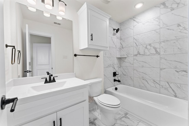 full bathroom featuring tiled shower / bath, vanity, and toilet