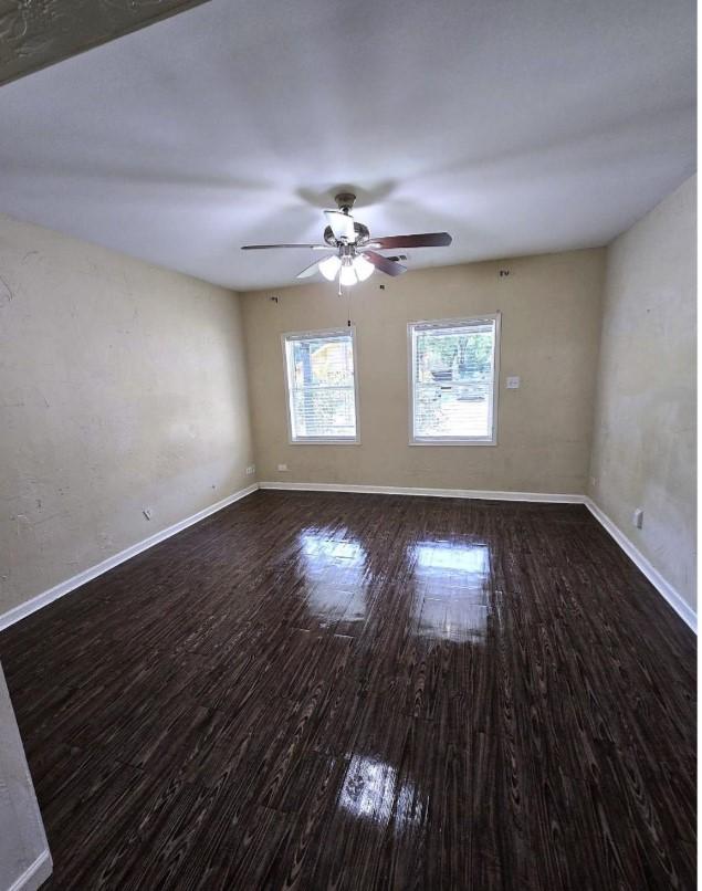 unfurnished room featuring dark hardwood / wood-style floors and ceiling fan