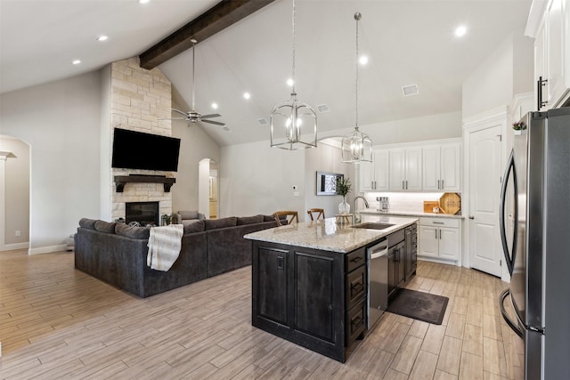 kitchen with white cabinetry, a kitchen island with sink, appliances with stainless steel finishes, and a sink