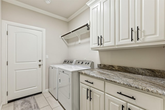 washroom with crown molding, light tile patterned floors, cabinet space, and washer and dryer