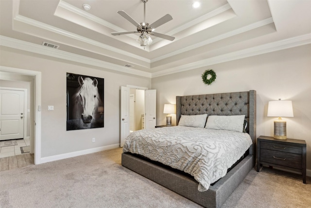 bedroom featuring light carpet, visible vents, a raised ceiling, and crown molding