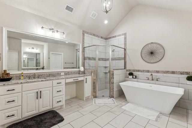 bathroom featuring a stall shower, a soaking tub, visible vents, and vanity