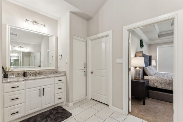 full bath featuring ensuite bathroom, ornamental molding, vanity, and baseboards