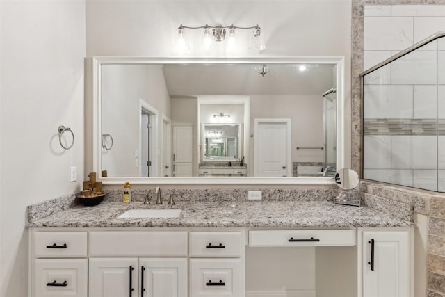 full bathroom with a stall shower and vanity