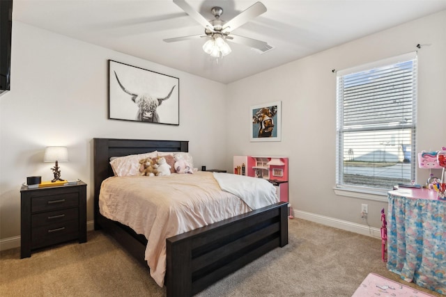 bedroom featuring light colored carpet, ceiling fan, and baseboards