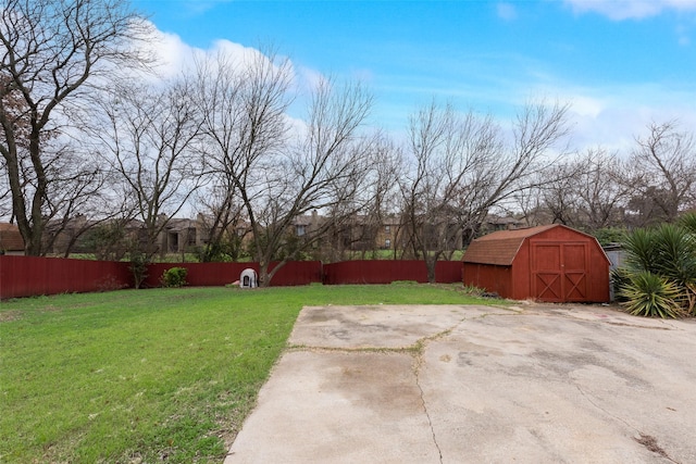 view of yard featuring a storage unit and a patio area