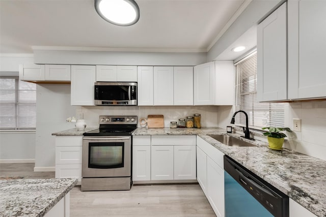 kitchen featuring white cabinetry, stainless steel appliances, and sink