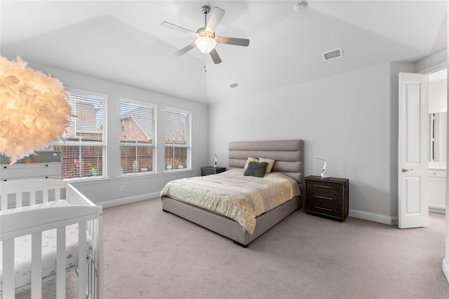 bedroom with light carpet, baseboards, visible vents, and vaulted ceiling