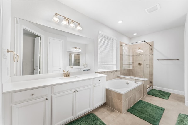 bathroom featuring tile patterned flooring, visible vents, vanity, a bath, and a stall shower