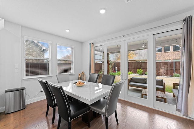 dining space featuring baseboards, dark wood finished floors, and recessed lighting