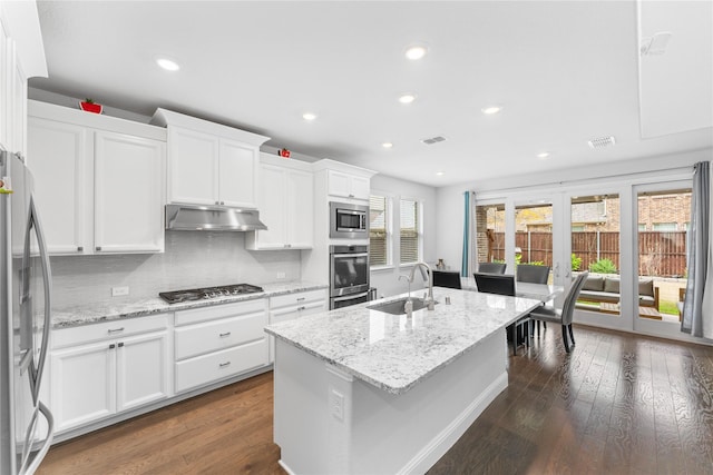 kitchen featuring a center island with sink, white cabinets, appliances with stainless steel finishes, under cabinet range hood, and a sink