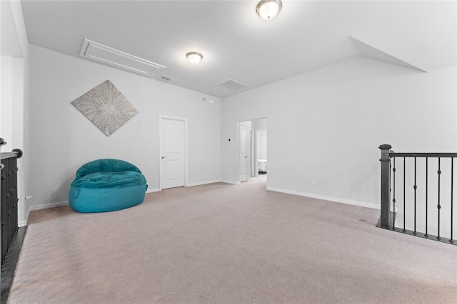 living area with visible vents, carpet, attic access, and baseboards