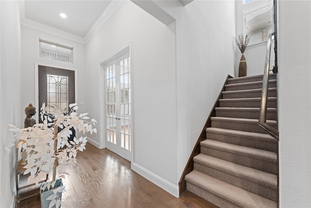 entryway featuring dark wood finished floors, recessed lighting, ornamental molding, baseboards, and stairs