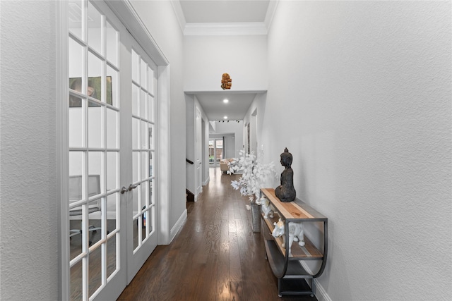 hall featuring baseboards, ornamental molding, dark wood-style flooring, and french doors