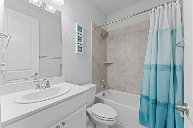 full bath featuring toilet, shower / bath combo, vanity, and a textured wall