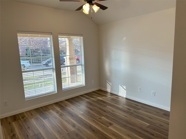 spare room with dark wood-type flooring, ceiling fan, and vaulted ceiling