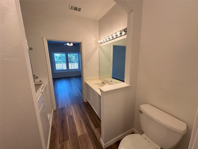 bathroom featuring hardwood / wood-style flooring, vanity, and toilet