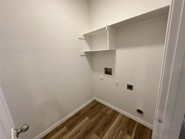 laundry area with electric dryer hookup, hookup for a washing machine, dark wood-type flooring, and gas dryer hookup